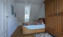 Schlafzimmer mit Doppelbett und Schrank